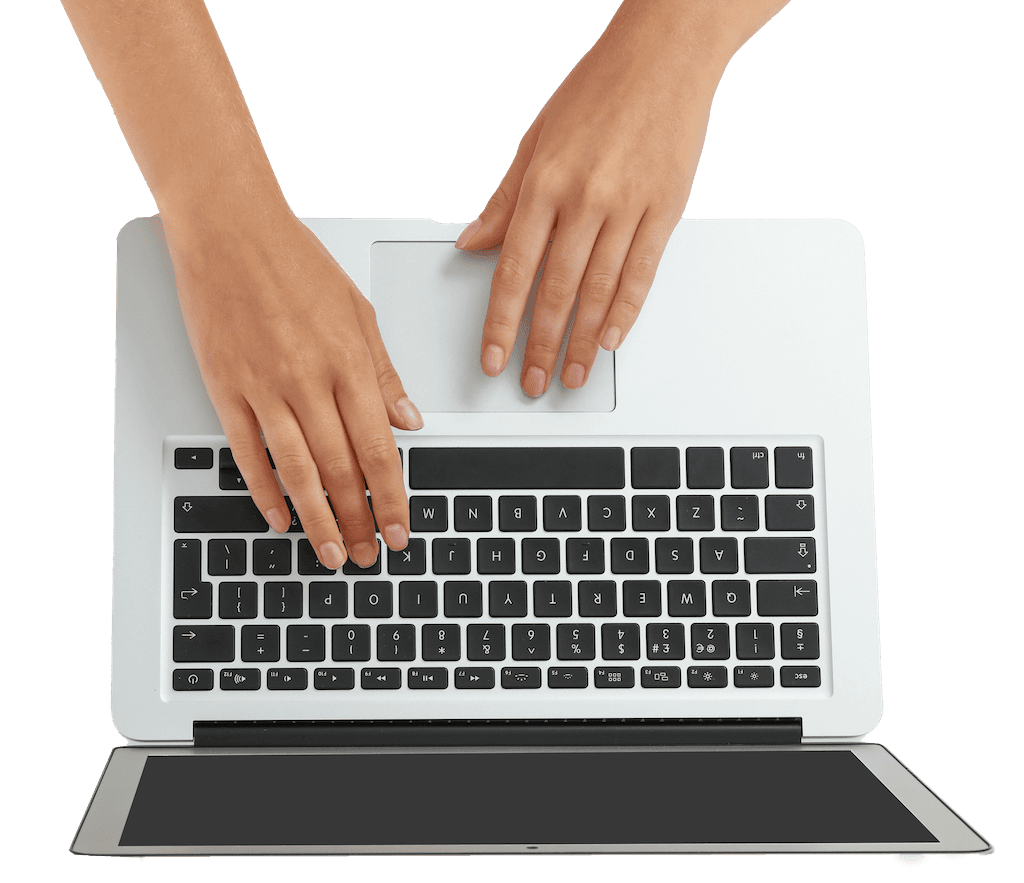 Hands typing on laptop keyboard to create personal memoir story.
